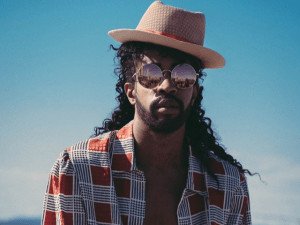 Black Man wearing printed shirt and brown hat
