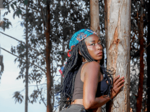 Woman wearing black top beside a tree