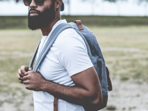 Man in white shirt and blue bag