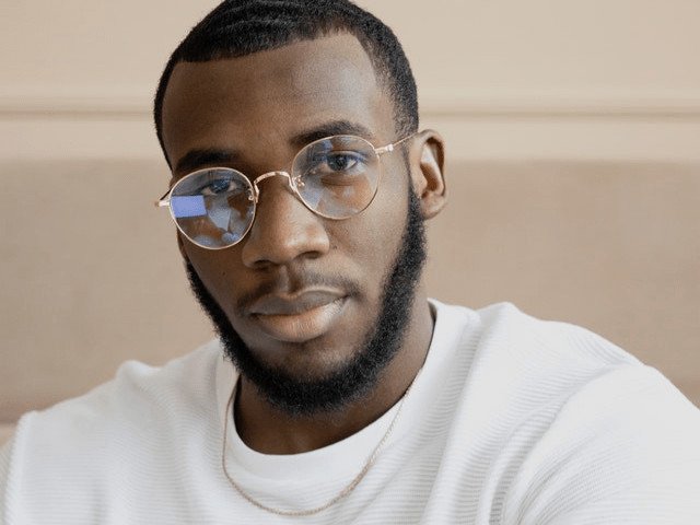 black man wearing eyeglasses and white shirt