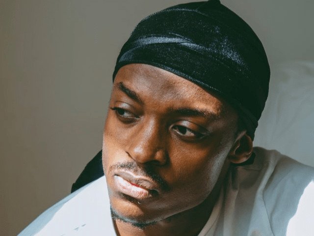 man in white shirt and durag