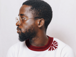 black man in red and white shirt