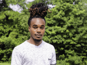 black man in white shirt in a forest