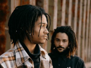 two men standing near a wall