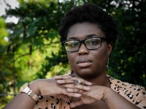 woman wearing glasses and brown shirt