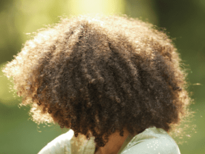 back view of a woman with curly hair