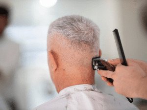 person using a hair razor on a man