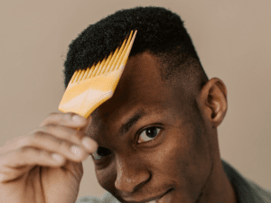 man combing curly hair