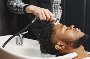 guy having hair washed in salon - featured image